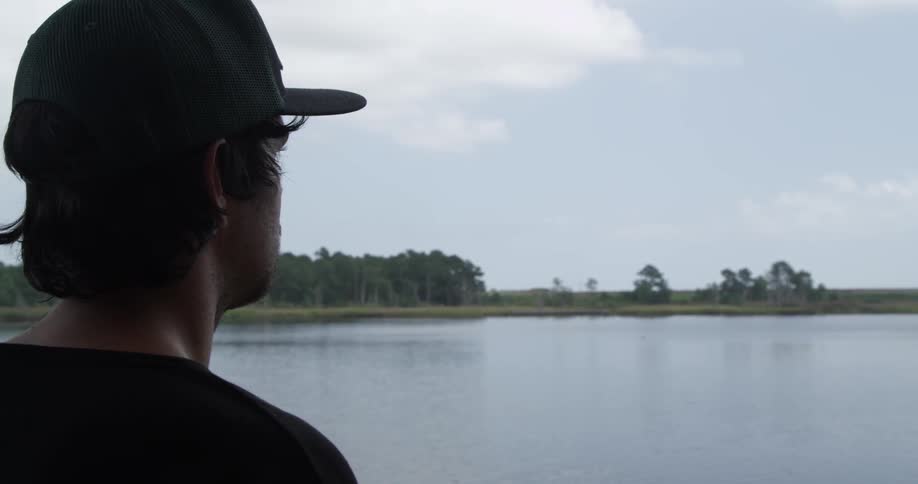 Man gazing out at a lake