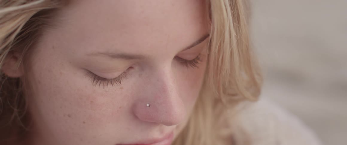 A woman has a nose piercing