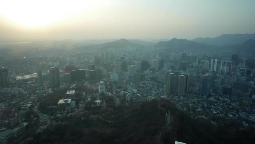 Aerial view of a smoggy city at dawn