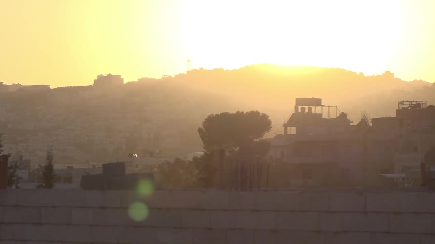 Sun setting over a foreign city