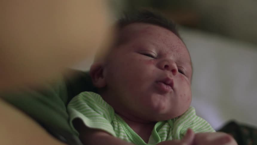 A woman holds a baby