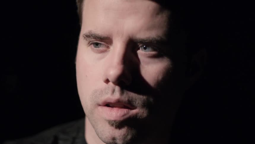 A man standing and looking concerned