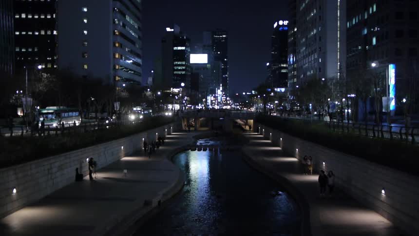 A waterway amidst a large city at night