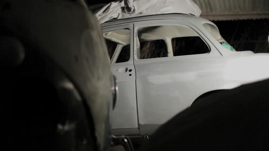 A man opens the doors of a car
