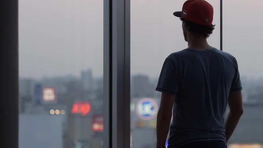 A man looking out thru a window
