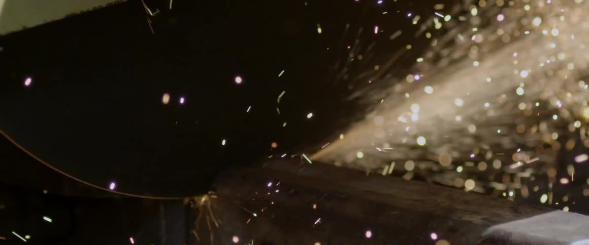 A saw blade cutting through steel and making sparks fly