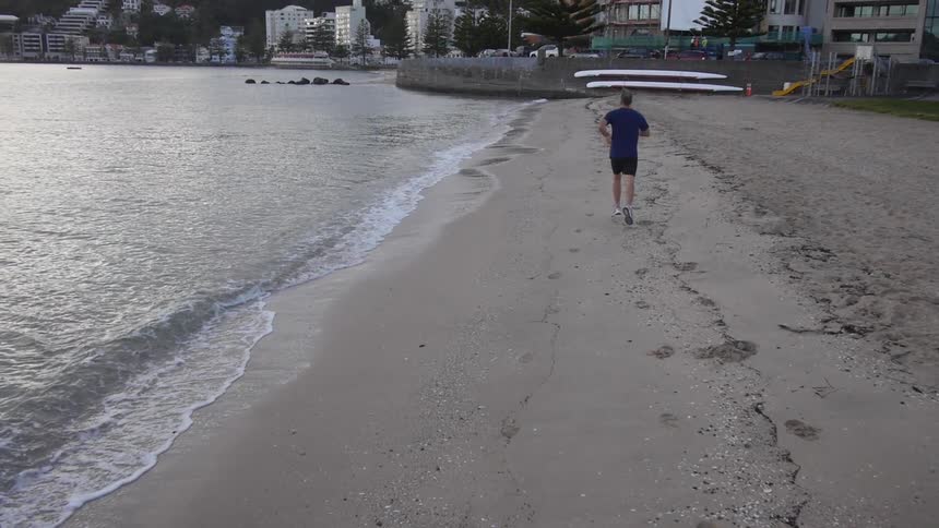A man jogs down the street