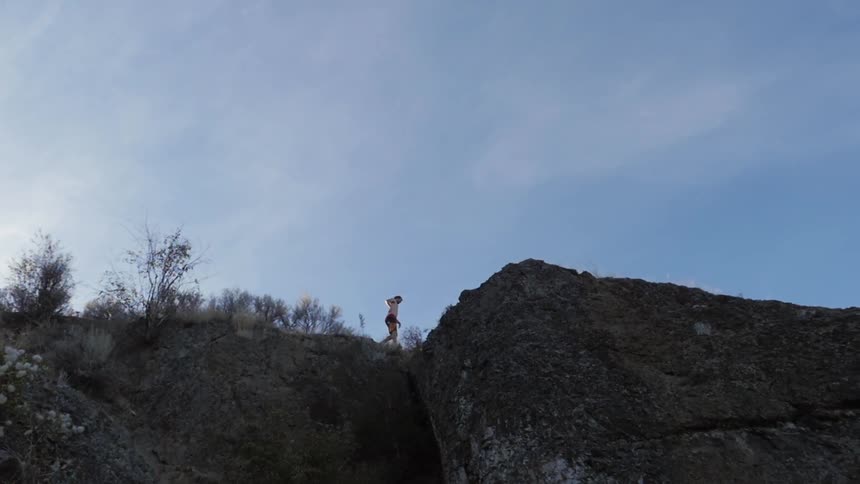 A person walking along a cliff side