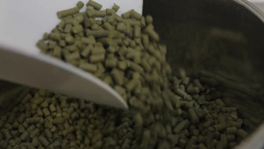 Pellets are scooped in a bin