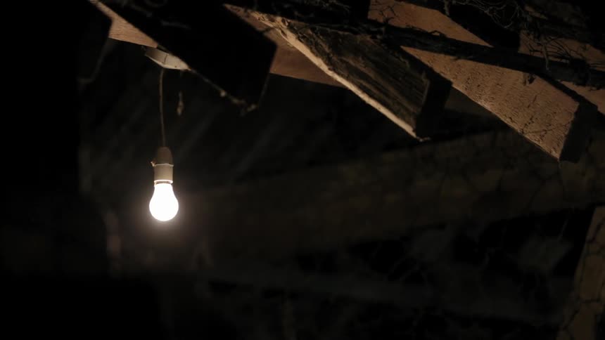 A single light bulb shining in a basement