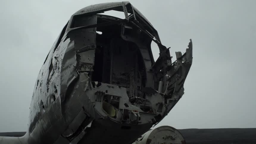 The wreckage of a plane crash in an empty field