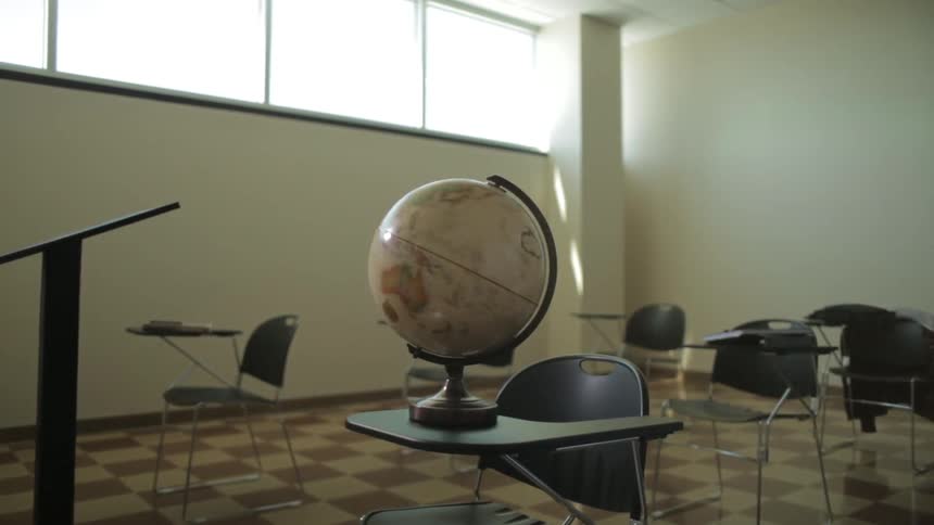 A globe spins inside a classroom