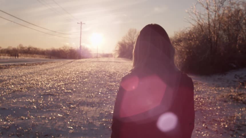 A person walking along in the snow
