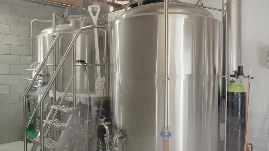 Steam billowing around two large tanks