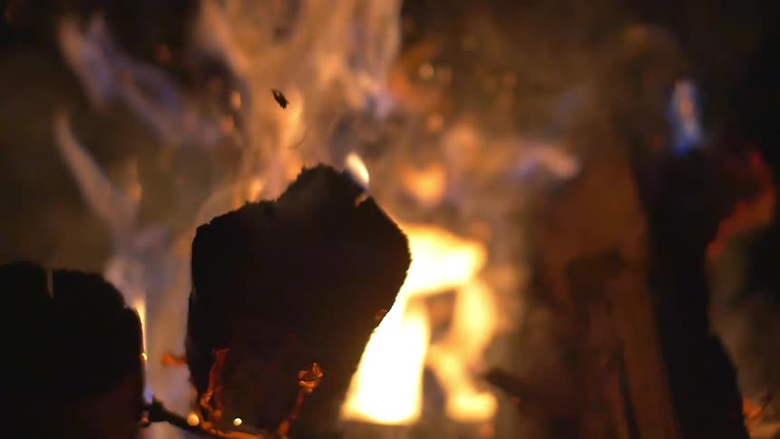 Fire erupting from burning wooden logs