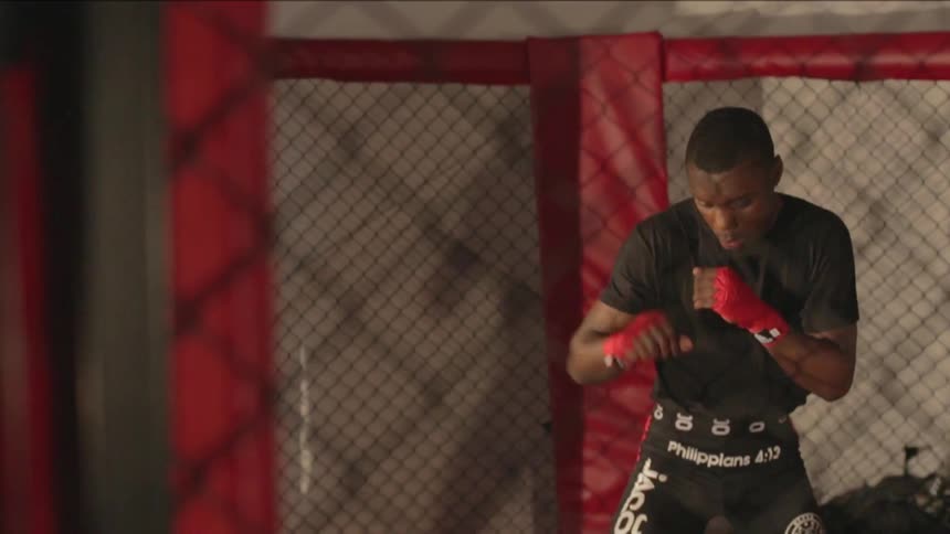 A person fighting in a cage