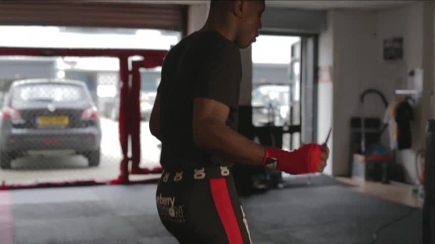 A man is jumping rope indoors