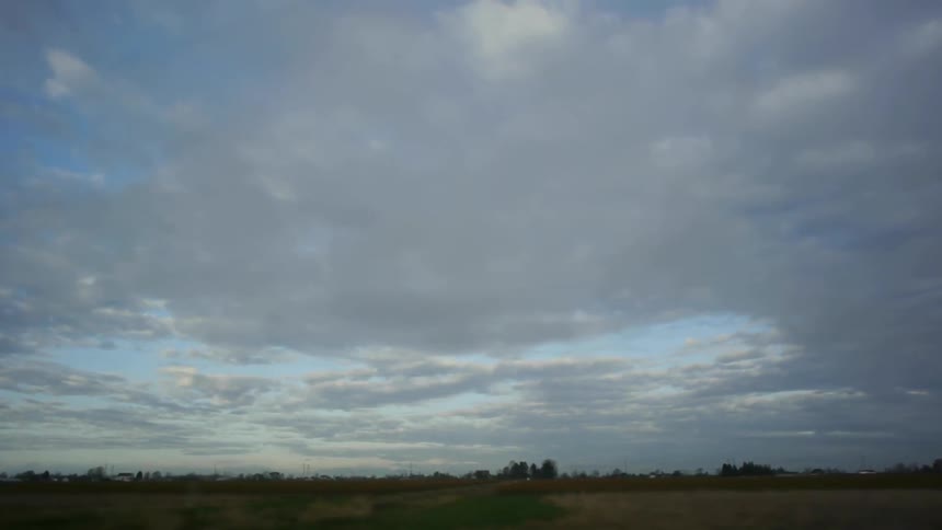 Clouds float over a field