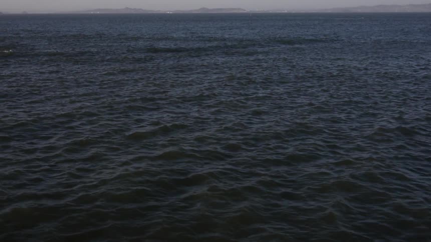 Dark Ocean water land at horizon