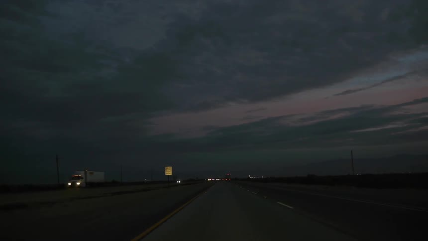 Driving down a large highway at twilight