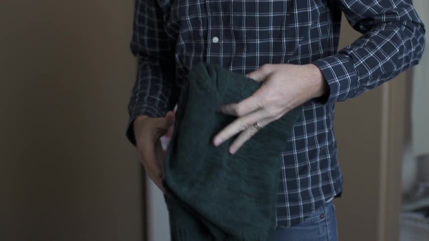 A person folding clothes