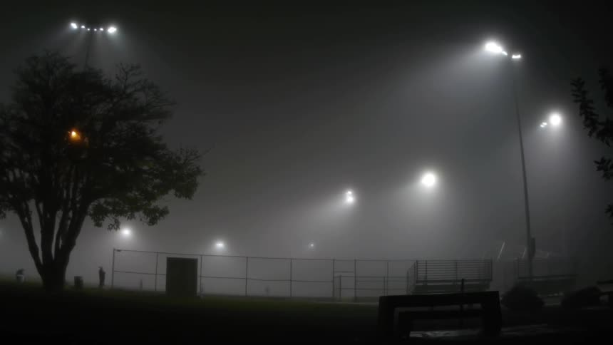 Night lights illuminate a baseball field