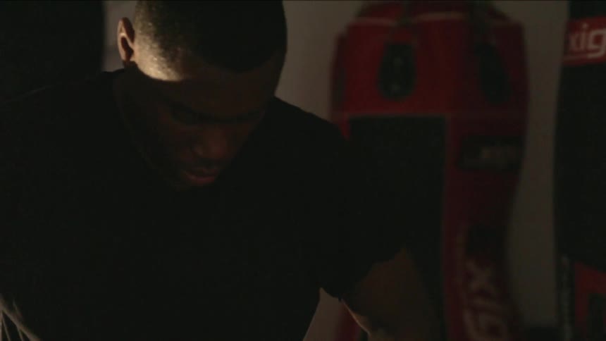 Determined man pacing in a boxing studio