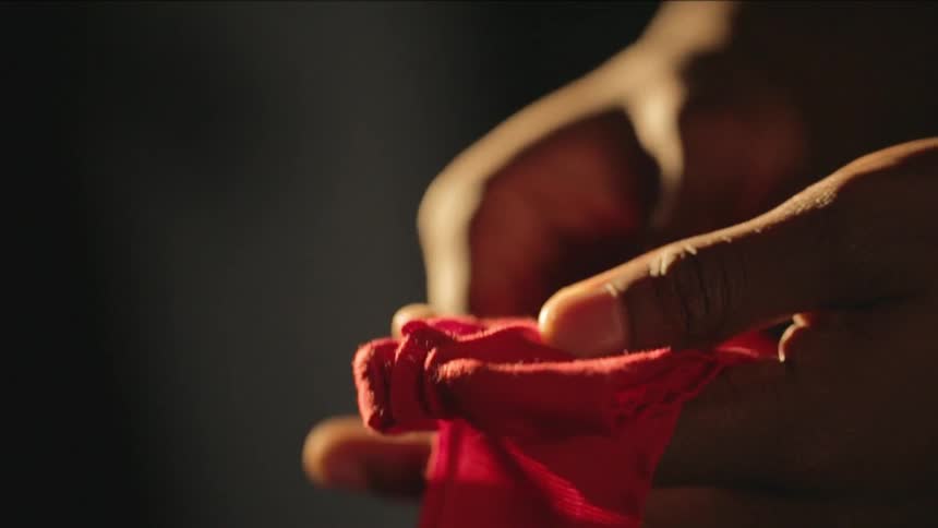 A person folding a piece of cloth