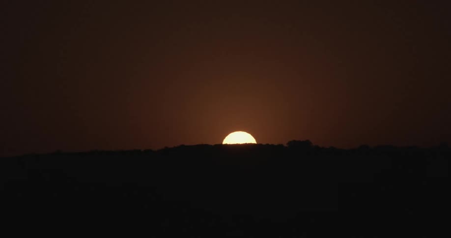 A sunset over a hilltop