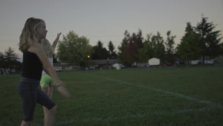 Kids do cartwheels on a field