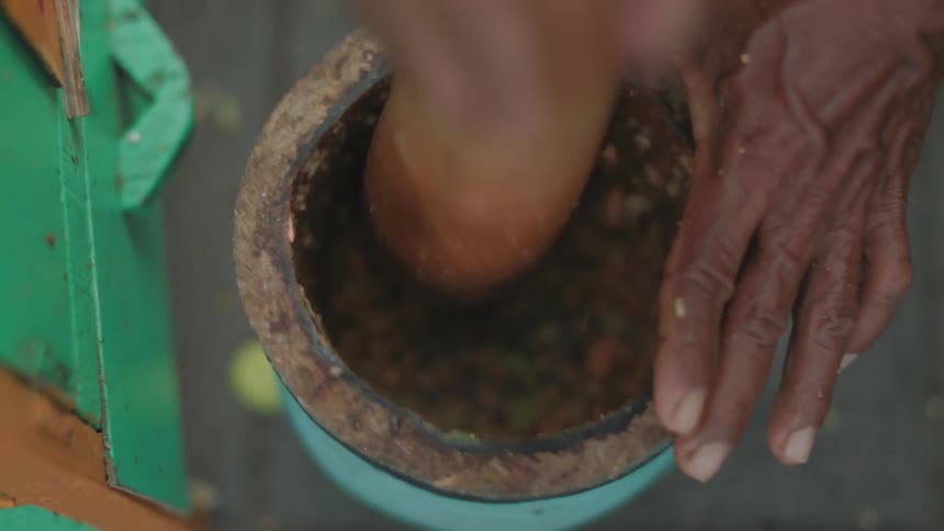 A person using a mortar and pestle