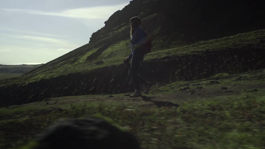 Woman walking quickly downhill