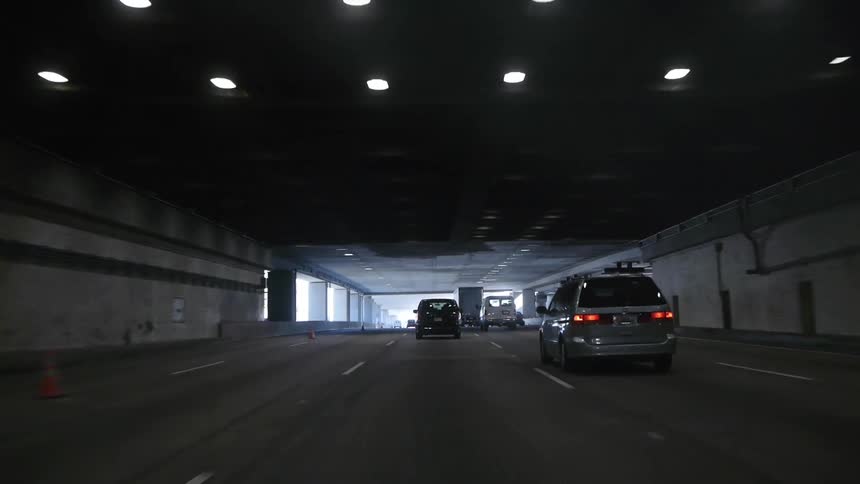 Cars driving down a tunnel