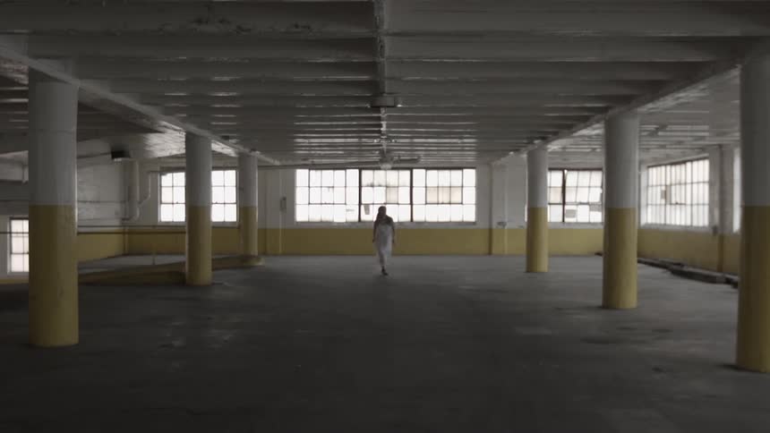 A person running through an abandoned building