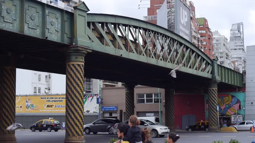 Vehicles pass under a city bridge