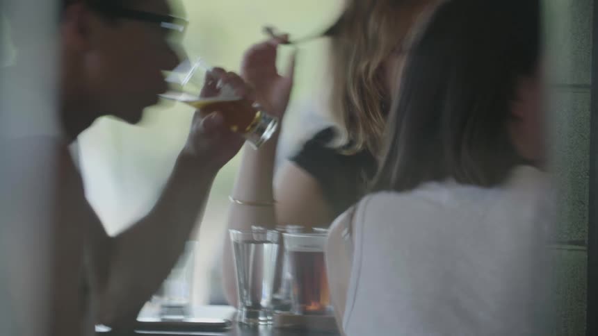 A person drinking a beer