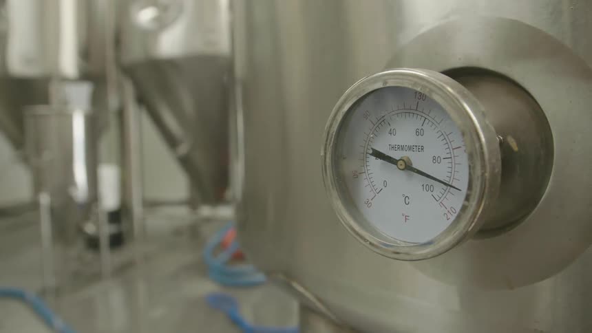 A gauge on industrial equipment moves slightly