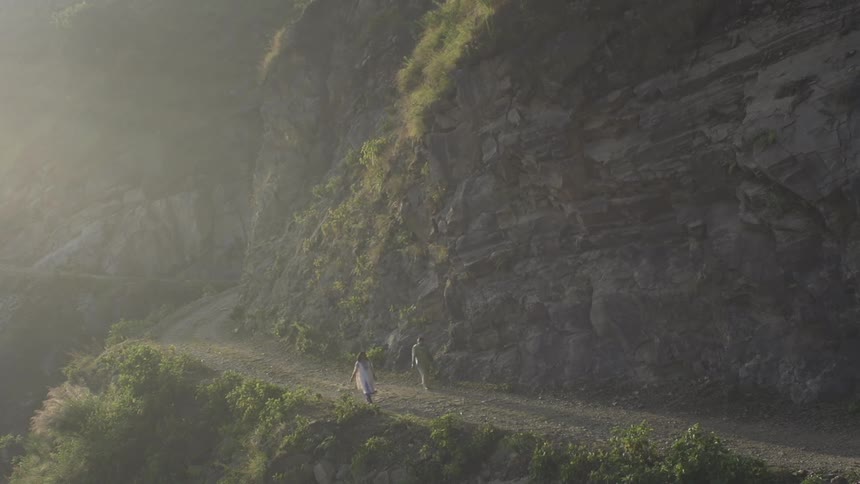 A couple walking along a cliff side