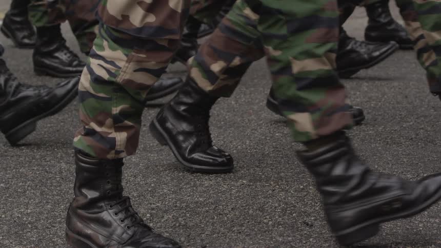 People in fatigues marching