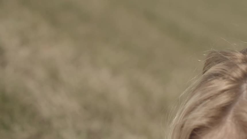 A woman crawling thru the grass