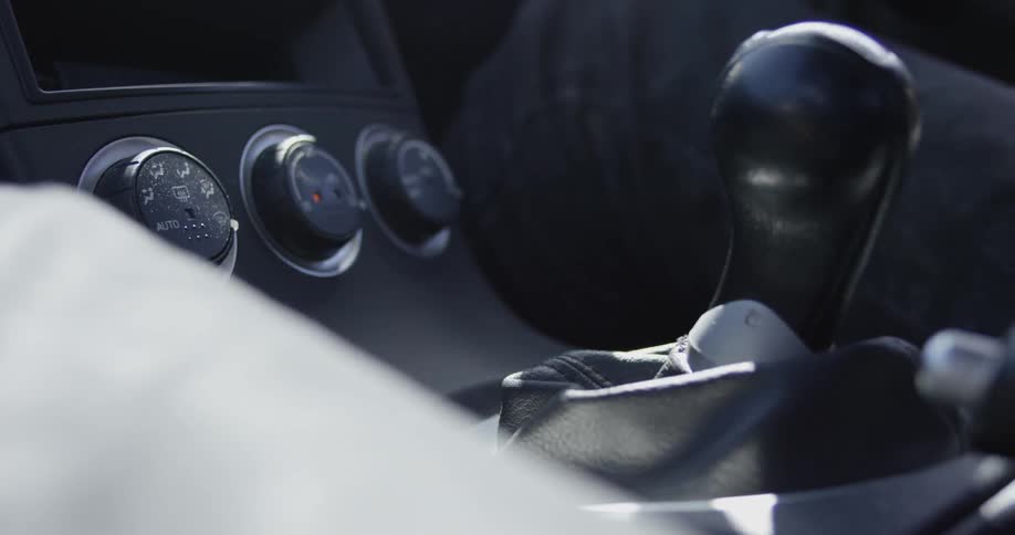 A person shifting gears