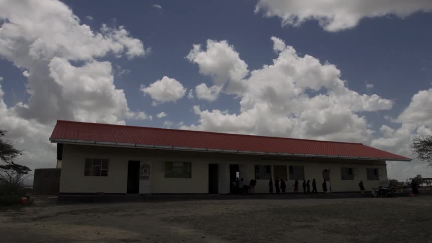 Several people leaving a one-story building