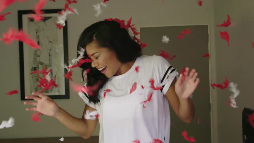 A woman happily celebrate at her house