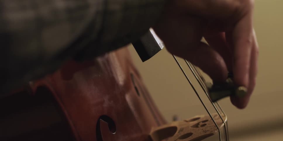 Close up of person playing a cello
