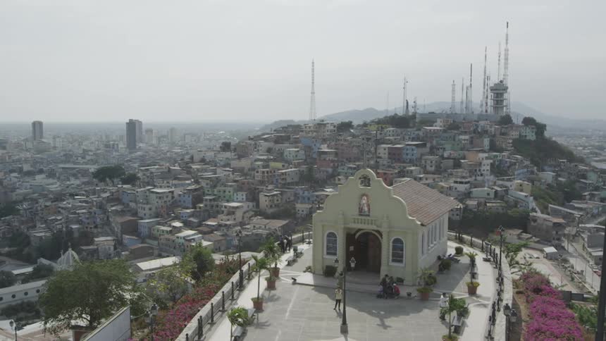 A small building overlooks a city
