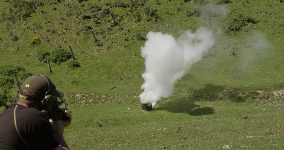 A person discharging a weapon