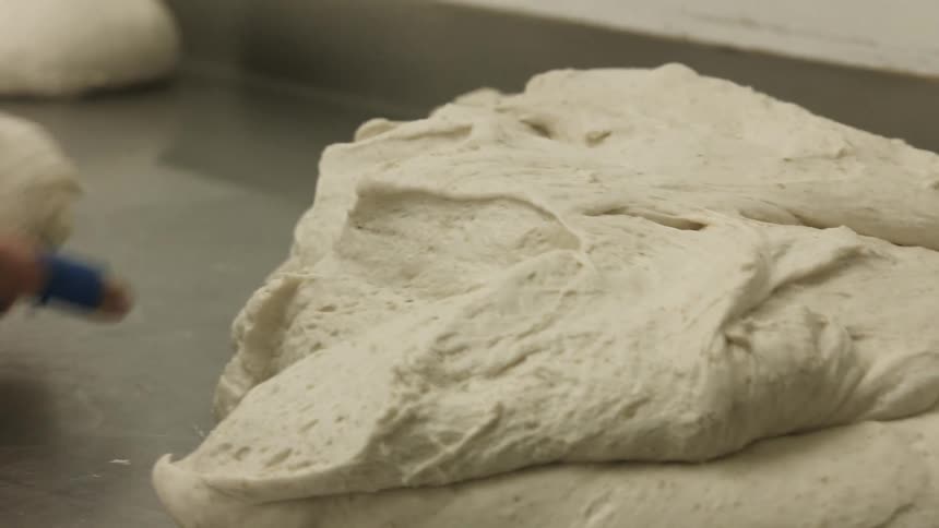 A person rolling dough