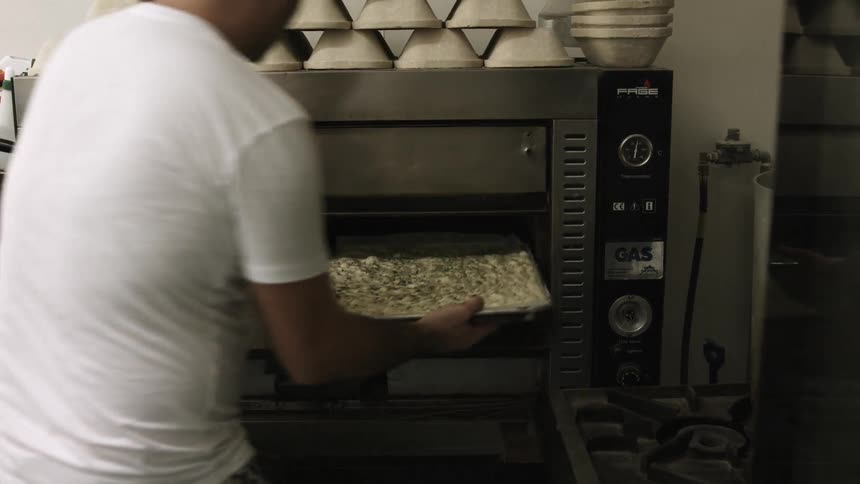 A person putting something in an oven