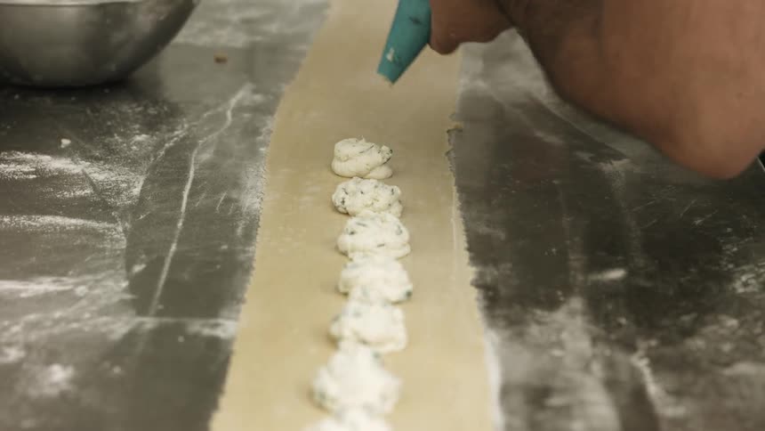 Filling is piped into pastry dough