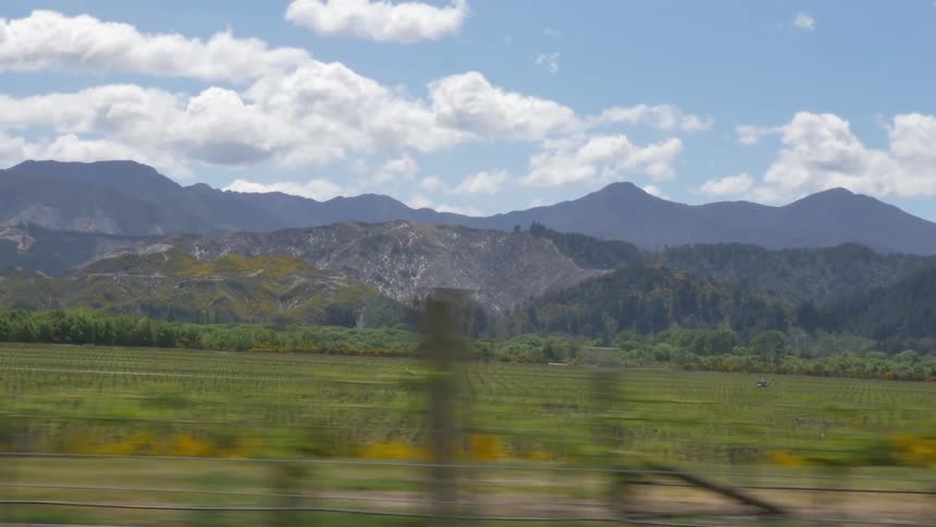 Clouds float over the mountains on a sunny day